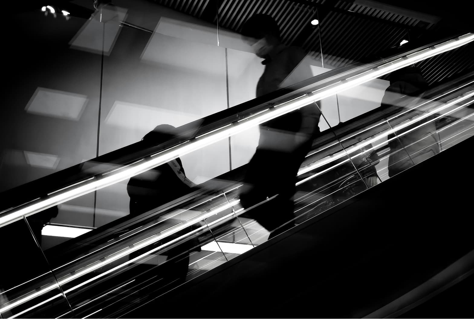 black and white photo of someone walking down stairs.